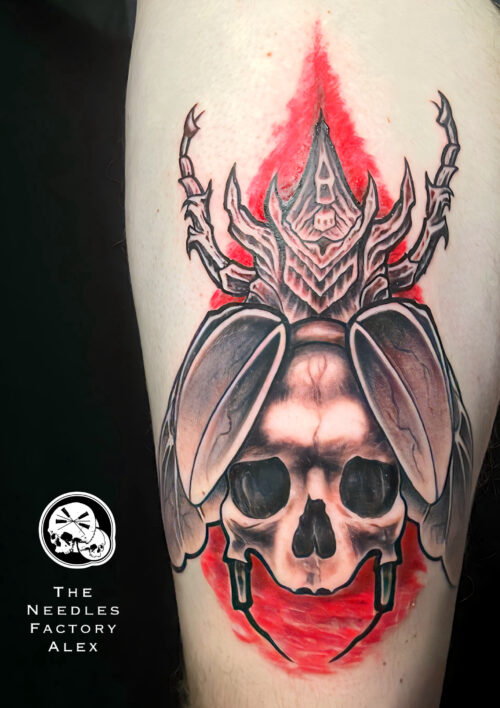 Tatouage cuisse scarabée crâne noir rouge